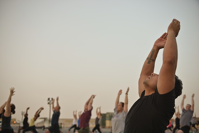 A group of people doing stretching outside.