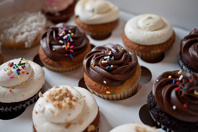 Assorted colorful cupcakes on a display.