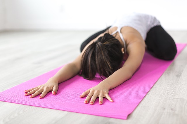 A woman performing yoga exercises.