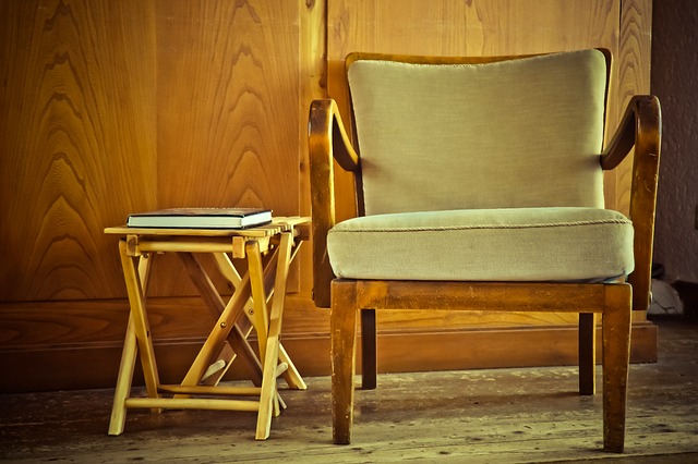 Minimalistic chair against a soft, textured wall background.