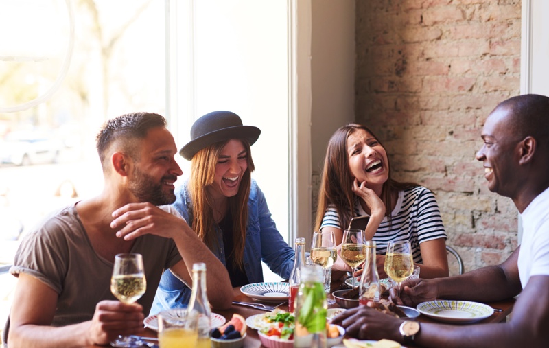 Friends having a hearty meal and a laugh.