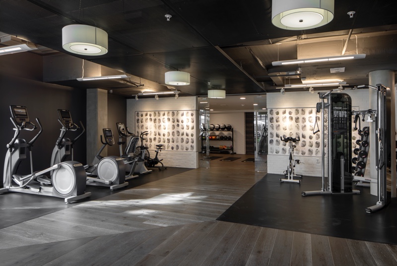 Inside a fitness center with gym equipment.