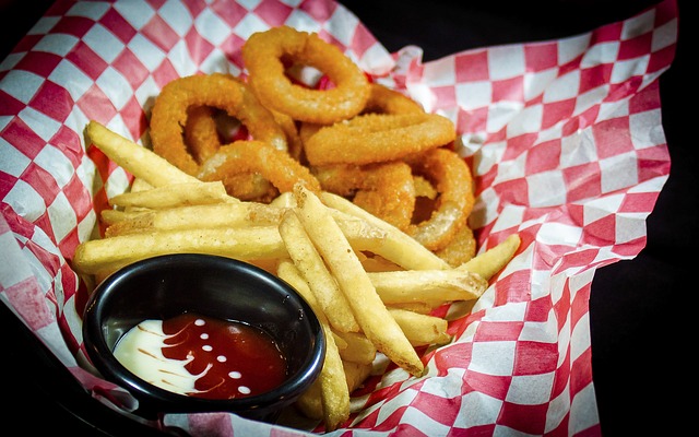 Onion rings and fries with mayo and ketsup.