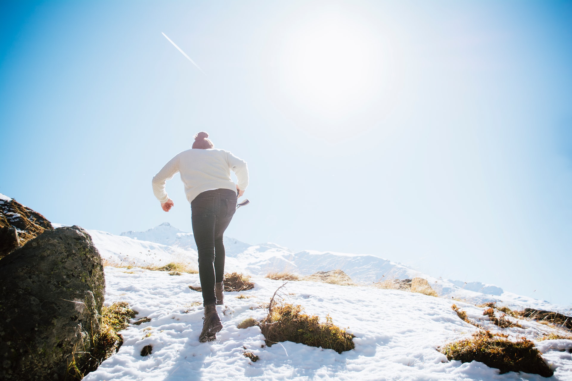 A man trekking on a snowy mountain.