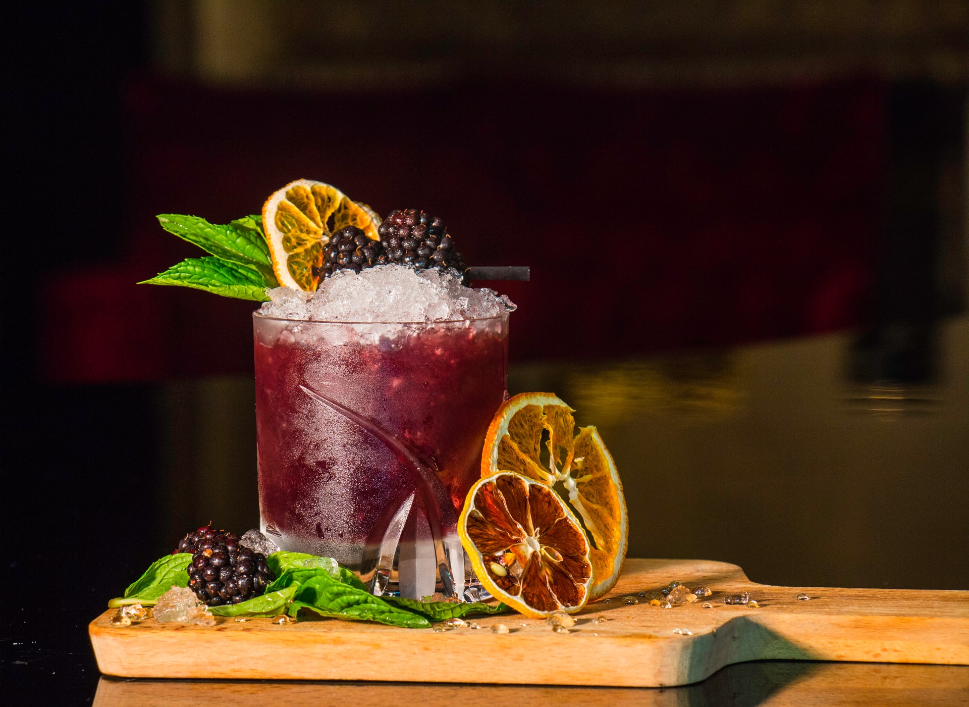 A refreshing cocktail garnished with orange slices and fresh mint leaves.