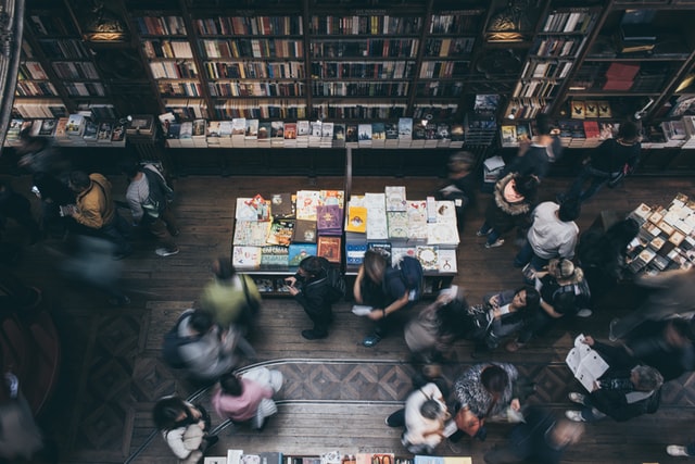 Group of people browsing books in a bookstore.