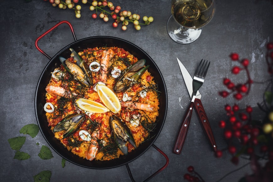 A delicious seafood and vegetable paella in a pan.