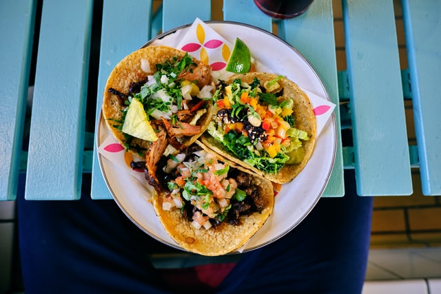 A plate with three delicious tacos.