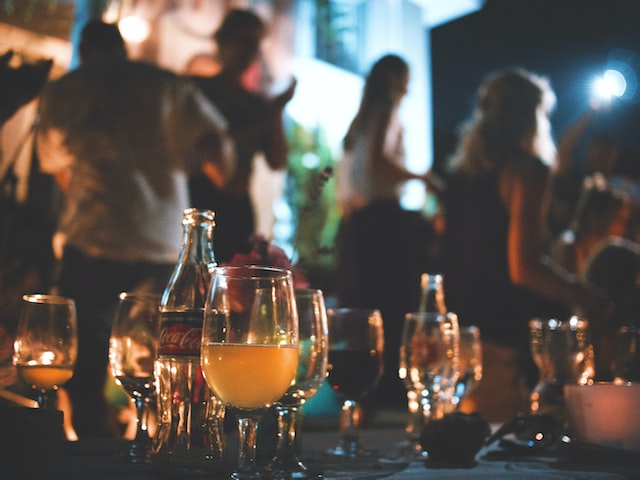 Table at a bar with drinks. People in the background.